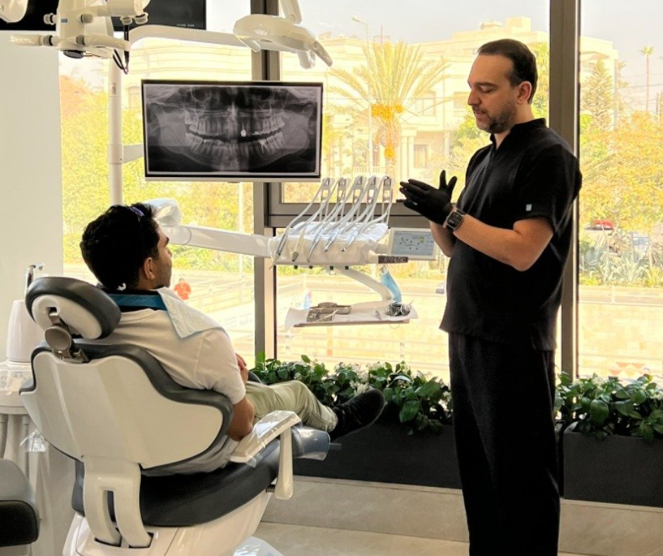 Dr. Hasan providing pre-operative and post-operative instructions to a patient following root canal treatment
